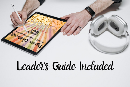 Person using a tablet with the Popcorn Christianity Leaders guide on the screen, next to headphones and a pen, on a white surface.