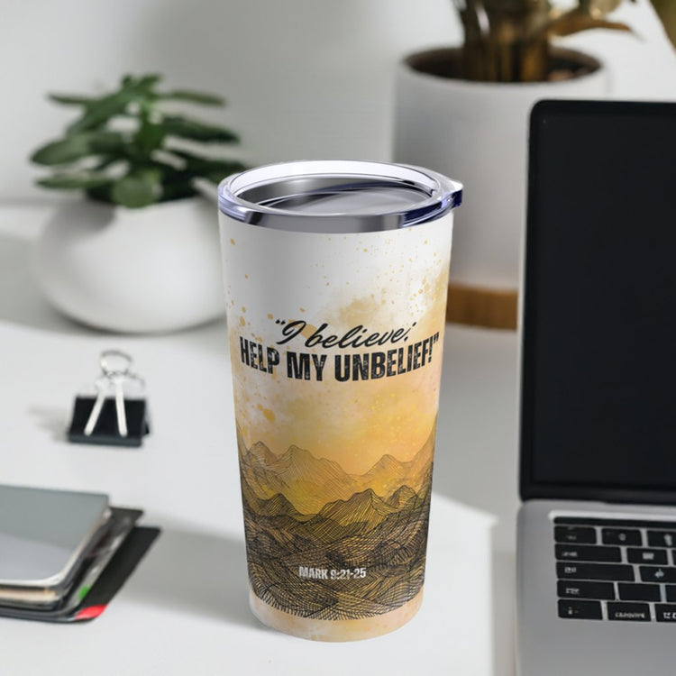 Living Water Christian Travel Mugs example "I believe Help my Unbelief" insulated tumbler with lid, sitting on a desk next to a laptop and day planner. 