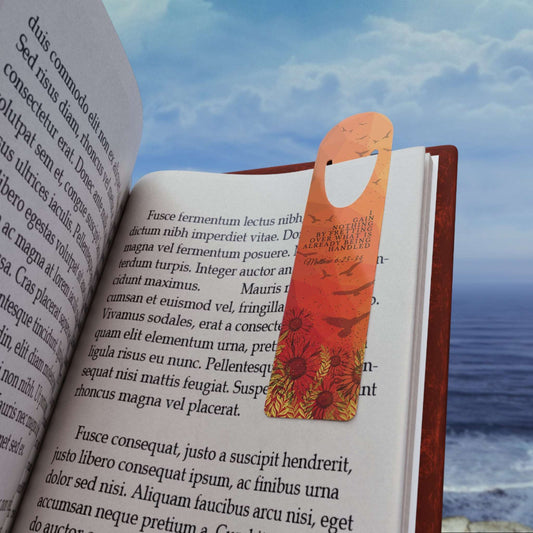 "I Gain Nothing by Fretting" -Matthew 6:25-34 Christian Bookmark Front view in use on example book page on the beach.