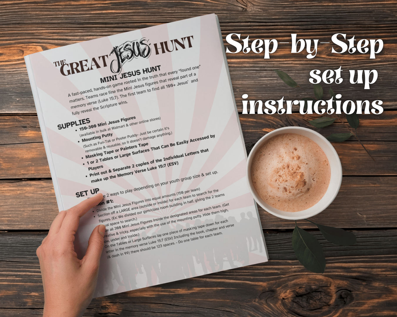 Hand holding a sheet of paper titled 'The Great Jesus Hunt', step-by-step setup instructions with a cup of coffee on a wooden surface.